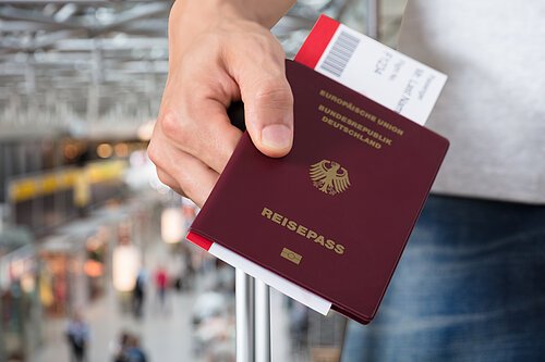 Person With Luggage Holding Passport And Boarding Pass Tickets