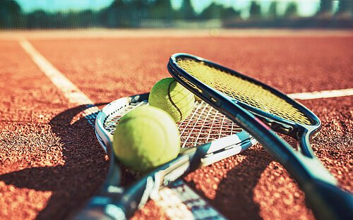 Tennis ball with racket on the tennis court. Sport, recreation c